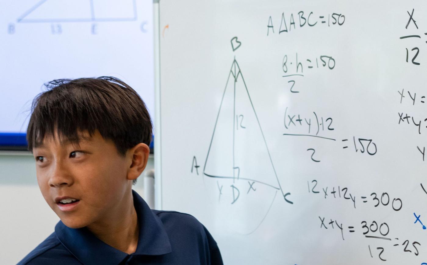 AoPS Middle School or High School student solves problem using equations on whiteboard